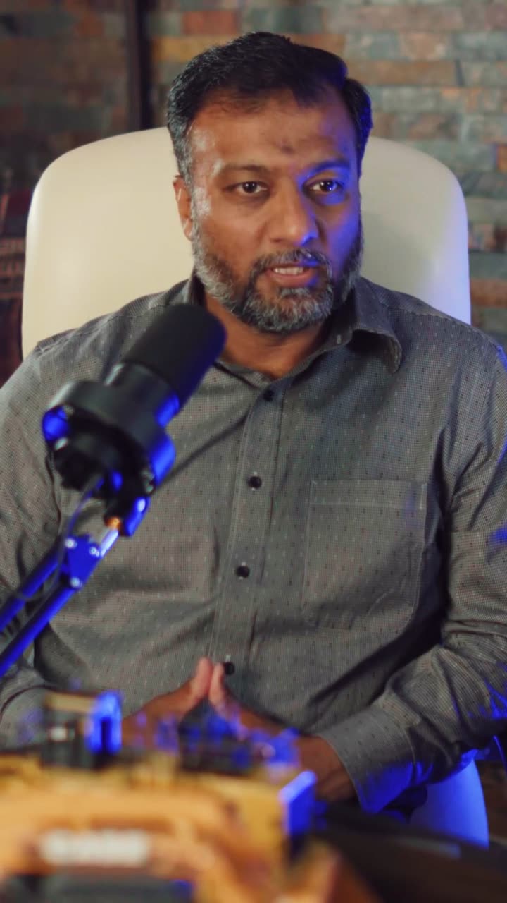 A company leader filmed behind a podcast microphone in the S5L studio