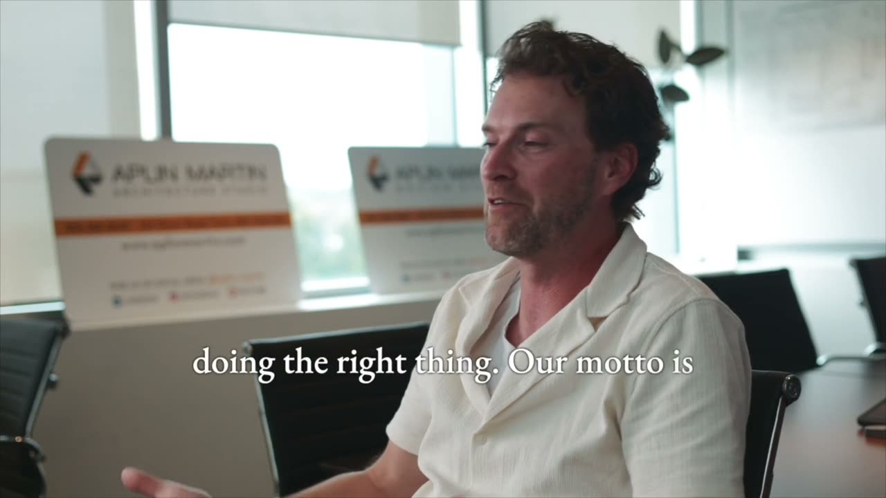 A customer speaking to camera in an Aplin Martin meeting room, from a testimonial film shot for Platinum Construction
